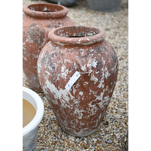 31 - A pair of weathered Grecian style terracotta urns to/w a pair of glazed planters (4)