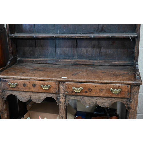 330 - A small antique oak cottage dresser with two shelves over two drawers and slatted pot board undertie... 