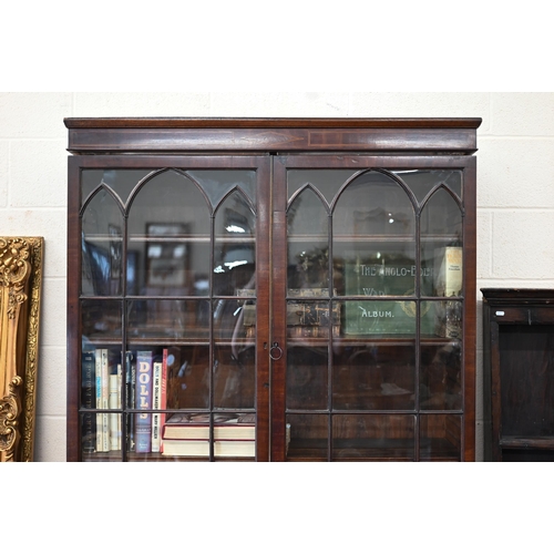 331 - A 19th century mahogany secretaire bookcase with glazed doors enclosing three shelves over the base ... 