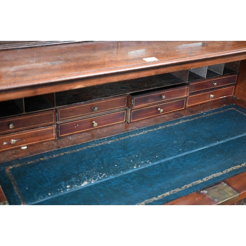 331 - A 19th century mahogany secretaire bookcase with glazed doors enclosing three shelves over the base ... 