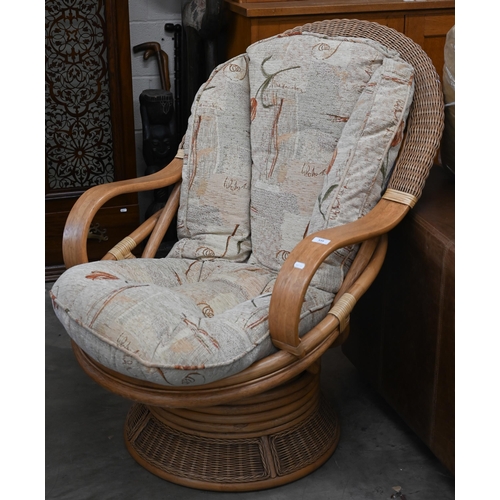 339 - A Daro Shaved cane and rattan swivel armchair with padded cushions in Rochelle fabric to/w matching ... 