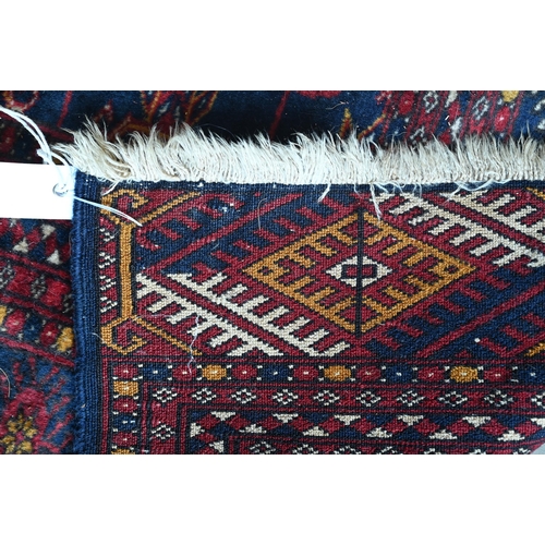 349 - A Pakistani teke Bokhara rug, the repeating gul design on blue ground within repeating borders, 185 ... 