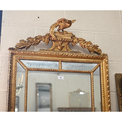 351 - A large rectangular wall mirror in decorative gilt frame with foliate supported pedestal crest surmo... 