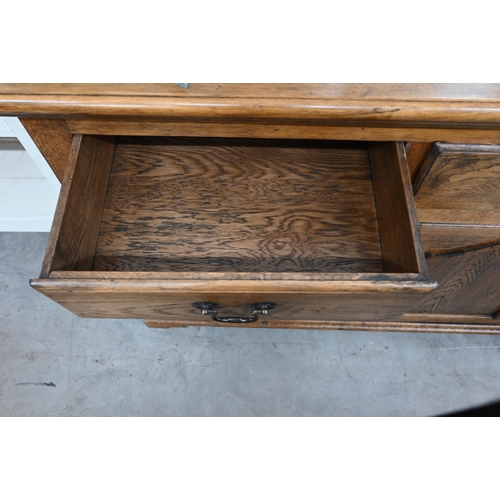 368 - A good quality modern oak sideboard with three drawers over panelled cupboards standing on bracket f... 