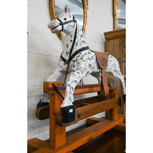 372 - A traditional painted (dappled) wooden children's rocking horse, 115 cm wide x 50 cm deep x 85 cm hi... 