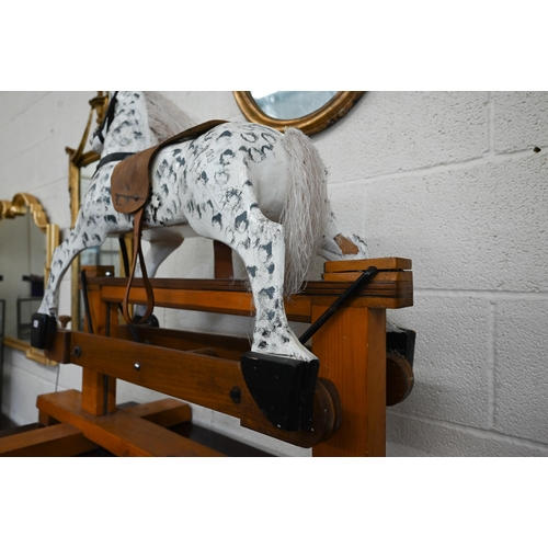 372 - A traditional painted (dappled) wooden children's rocking horse, 115 cm wide x 50 cm deep x 85 cm hi... 