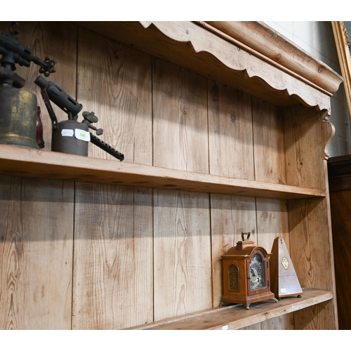 373 - A large antique pine dresser with plate rack over three drawer base with cupped handles and shaped s... 