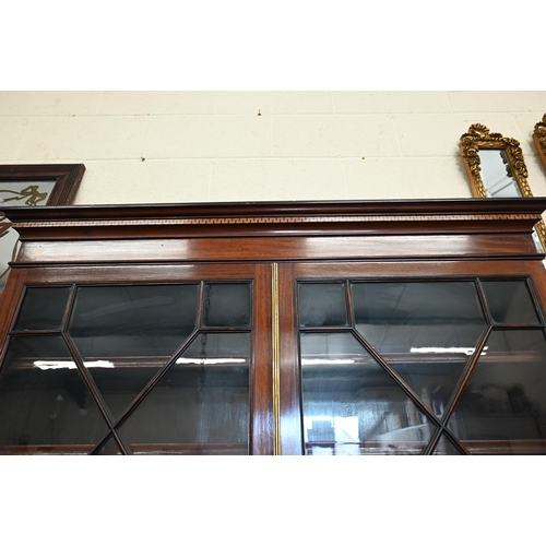 379 - A 19th century mahogany inlaid cabinet bookcase with astragal glazed doors over shallow drawer and p... 