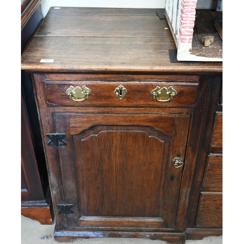 380 - Antique oak inverted breakfront low dresser with an arrangement of six drawers around panelled cupbo... 