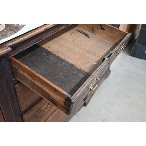 380 - Antique oak inverted breakfront low dresser with an arrangement of six drawers around panelled cupbo... 