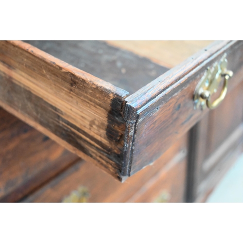 380 - Antique oak inverted breakfront low dresser with an arrangement of six drawers around panelled cupbo... 