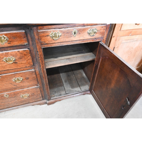 380 - Antique oak inverted breakfront low dresser with an arrangement of six drawers around panelled cupbo... 