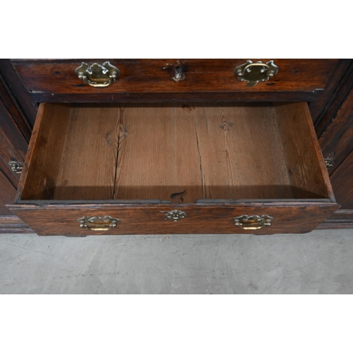 380 - Antique oak inverted breakfront low dresser with an arrangement of six drawers around panelled cupbo... 