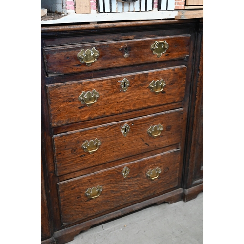 380 - Antique oak inverted breakfront low dresser with an arrangement of six drawers around panelled cupbo... 