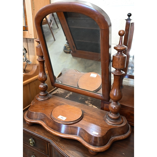 390 - # A Victorian mahogany framed toilet mirror on shaped platform base with bun feet, 58 cm wide x 24 c... 