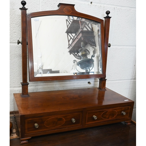 390 - # A Victorian mahogany framed toilet mirror on shaped platform base with bun feet, 58 cm wide x 24 c... 