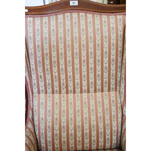 391 - # An Edwardian walnut framed salon armchair with floral striped upholstery