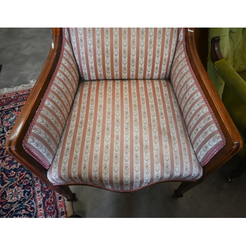 391 - # An Edwardian walnut framed salon armchair with floral striped upholstery