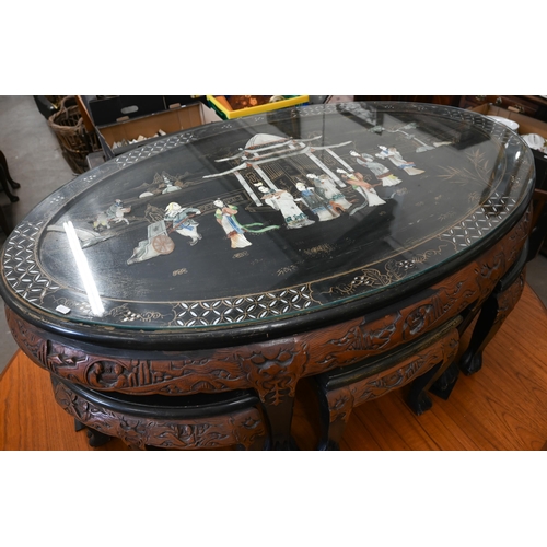 399 - A Chinese part lacquered and carved hardwood oval table, the top with applied imitation mother-of-pe... 