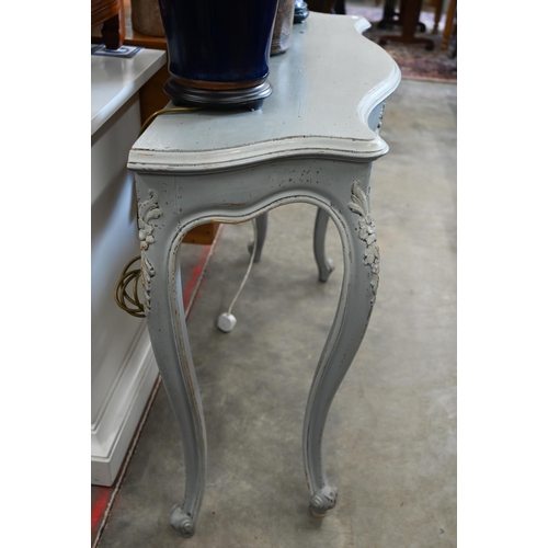 406 - A French grey painted serpentine console table with floral carved decoration, 112 cm wide x 38 cm de... 