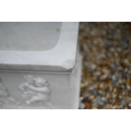 41 - An antique style marble trough planter with relief cut frieze depicting a procession of frolicking c... 