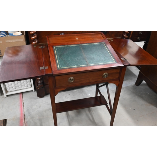 414 - An Edwardian mahogany pop-up writing table with twin hinged panelled top enclosing rise and fall two... 