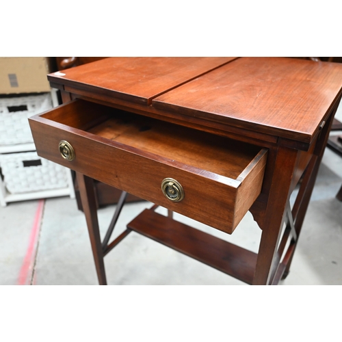 414 - An Edwardian mahogany pop-up writing table with twin hinged panelled top enclosing rise and fall two... 