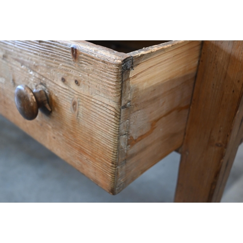 427 - An antique provincial waxed pine table with two deep frieze drawers on tapering supports, 146 cm x 8... 