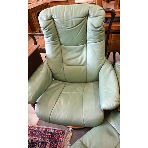 429 - Two Ekornes Stressless recliner armchairs in aqua green leather on classic base each with matching f... 