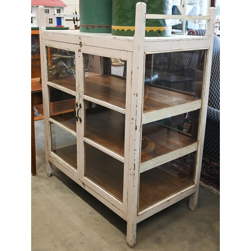 436 - A double sided painted and glazed curio cabinet with three shelves, 108 cm wide x 60 cm deep x 135 c... 