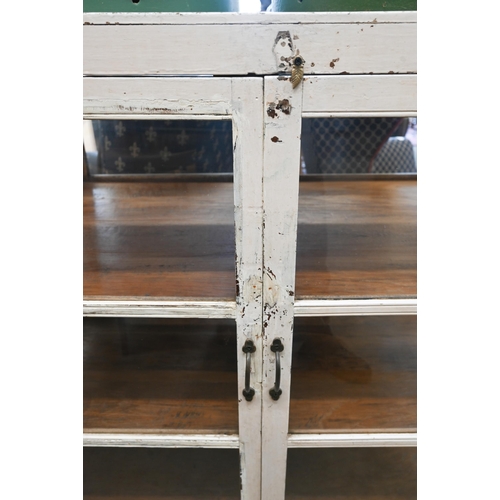 436 - A double sided painted and glazed curio cabinet with three shelves, 108 cm wide x 60 cm deep x 135 c... 