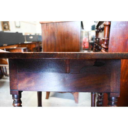 442 - A 19th century mahogany drop leaf side table with two drawers, turned supports and casters