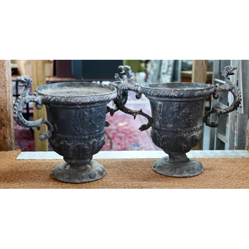 52 - A large pair of late 18th century lead urns with twin scroll serpent head handles, the bodies with r... 