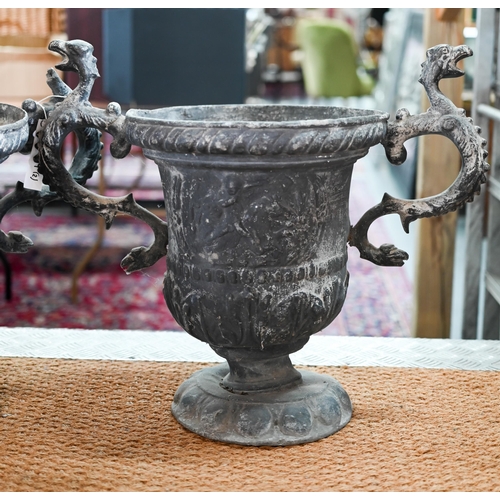 52 - A large pair of late 18th century lead urns with twin scroll serpent head handles, the bodies with r... 