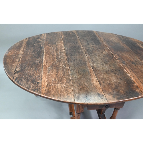 547 - An antique oak gateleg dining table