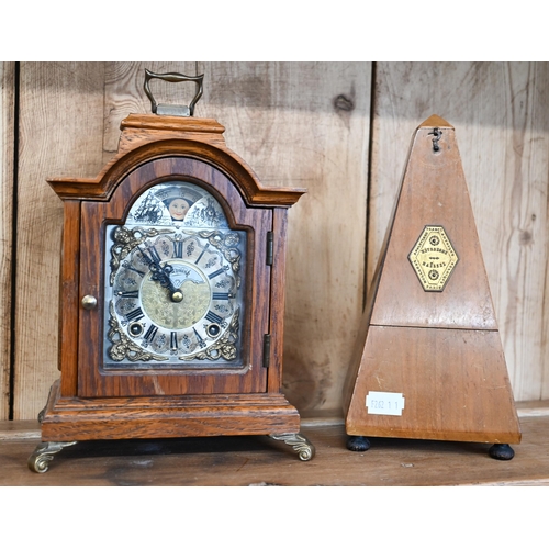 581 - A small oak cased mantel clock striking on a coiled gong, to/w a French metronome (2)