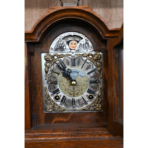 581 - A small oak cased mantel clock striking on a coiled gong, to/w a French metronome (2)