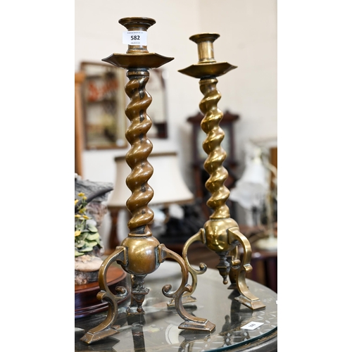 582 - Two large cast brass barleytwist candlesticks on tripod bases, 46 cm high