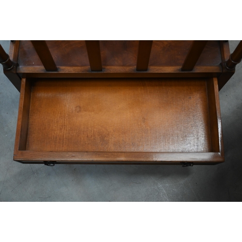 592 - A Victorian style three division Canterbury with drawer, on casters, 52 x 35 x 53 cm high