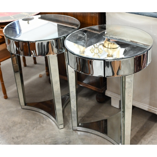 595 - A pair of Art Deco style circular mirrored occasional tables, with single frieze drawer on triform b... 