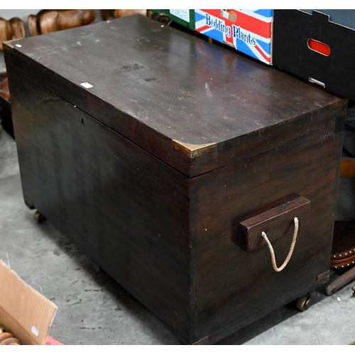 604 - An antique brass bound teak trunk with rope carrying handles, on castors 102 x 54 x 70 cm high