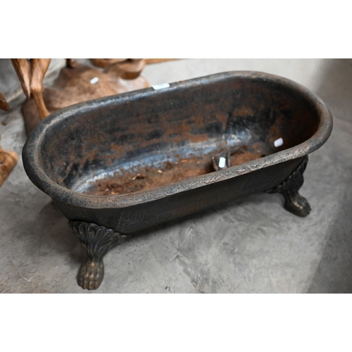 605 - An old cast iron planter trough raised on paw feet, 70 x 36 x 26 cm high