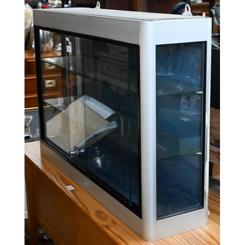 613 - A glazed alloy wall display cabinet, with glass shelves and 240 volt illumination, 92 x 22 x 61 cm h... 