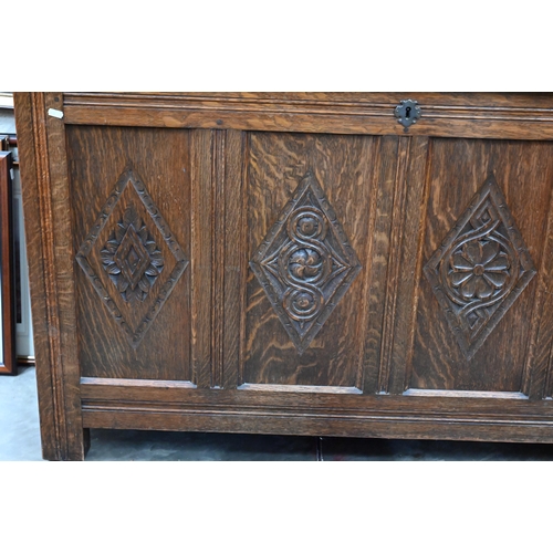 618 - A traditional oak coffer with carved lozenge decoration, on stile feet, 133 x 55 x 76 cm high