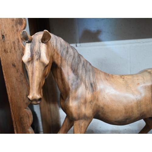 629 - A trio of carved hardwood stallion sculptures (3)