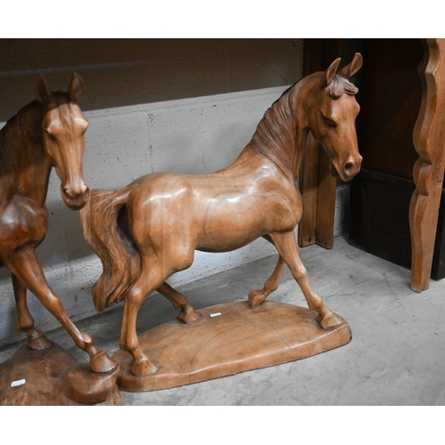 629 - A trio of carved hardwood stallion sculptures (3)