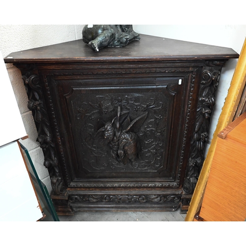 638 - A late 19th century carved oak corner cupboard