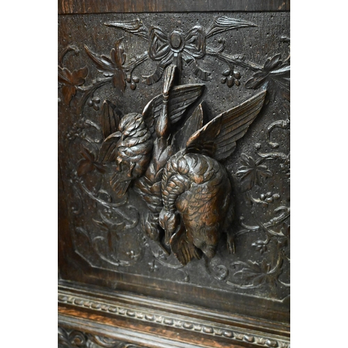 638 - A late 19th century carved oak corner cupboard