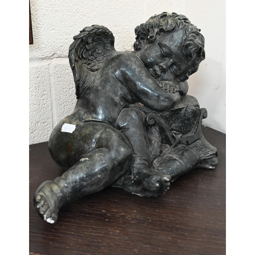 639 - A verdigris-patinated pottery recumbent putto in the Regency style