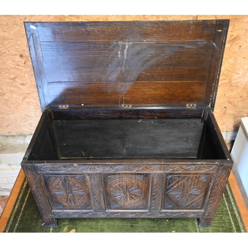 475 - A small carved panelled oak coffer with hinged top, 90 x 45 x 50 cm h